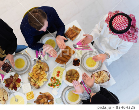Top view of Muslim family making iftar dua to break fasting during Ramadan Top view of Muslim family making iftar dua to break fasting during Ramadan 83464328