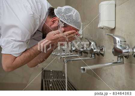 A Muslim takes ablution for prayer. Islamic religious rite A Muslim takes ablution for prayer. Islamic religious rite 83464363
