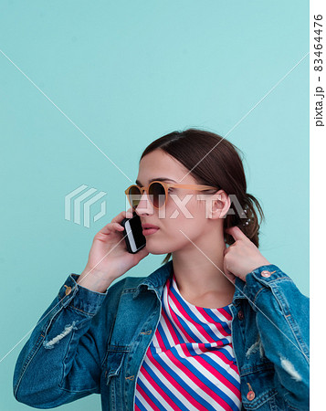 Portrait of young girl talking on the phone Portrait of young girl talking on the phone 83464476