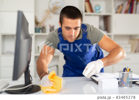 Cleaning worker wiping office desk with detergent Cleaning worker wiping office desk with detergent 83465278