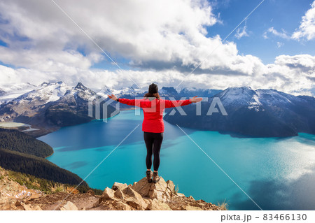 Adventurous Caucasian Woman hiking on top of a Canadian mountain. Adventurous Caucasian Woman hiking on top of a Canadian mountain. 83466130