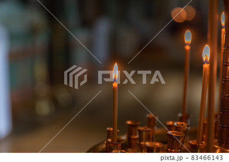 Orthodox Church. Christianity. Festive interior decoration with burning candles and icon in traditional Orthodox Church on Easter Eve or Christmas. Religion faith pray symbol. 83466143