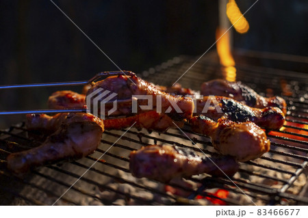 chicken drumsticks are grilled on a barbecue grill chicken drumsticks are grilled on a barbecue grill 83466677