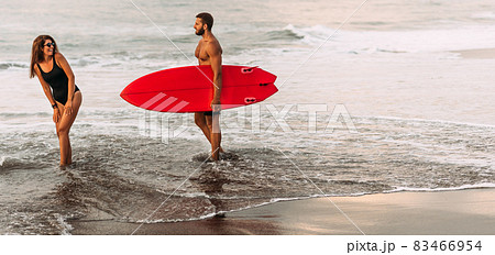 A couple in love on vacation on the ocean, panorama. Surfing on the shore of the paradise island of Sri Lanka. A married couple is resting on the sea. A happy couple by the sea. Holidays in Sri Lanka 83466954