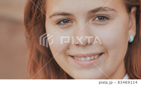 Portrait of a 16 year old red-haired smiling girl. 83469114