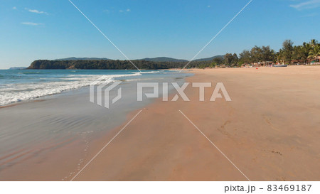 Low drone flight over the waves of Agonda beach. Goa State. India. Low drone flight over the waves of Agonda beach. Goa State. India. 83469187