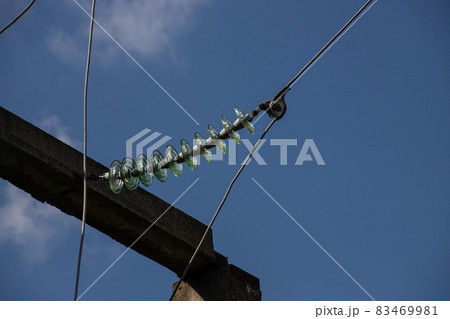 Power lines on background of blue sky close-up. Electric hub on pole. Electricity equipment with copy space. Wires of high voltage in sky Power lines on background of blue sky close-up. Electric hub on pole. Electricity equipment with copy space. Wires of high voltage in sky 83469981