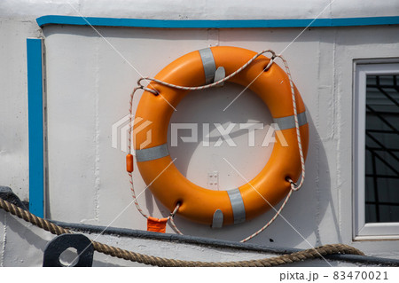 Lifebelt with lifeline on a white background on a ship Lifebelt with lifeline on a white background on a ship 83470021