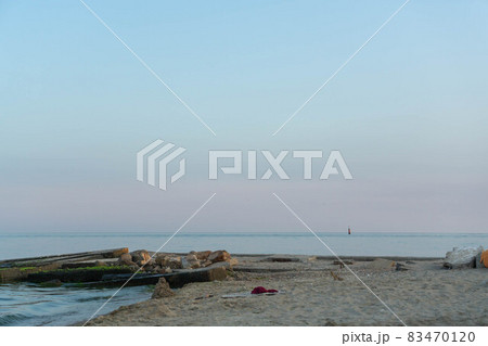 Sea waves run into a concrete pier. Night sea. 83470120