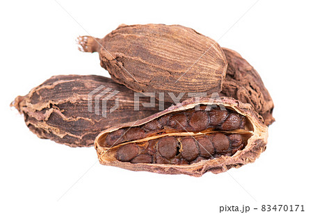 Heap of black cardamom pods isolated on white background. Black cardamon seeds. Clipping path. Heap of black cardamom pods isolated on white background. Black cardamon seeds. Clipping path. 83470171