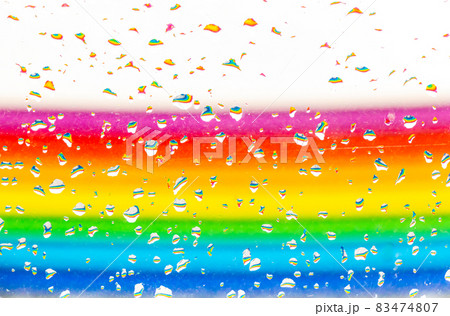 A rainbow behind a glass windows with water drops, Point of view, from behind the glass with drops. A rainbow behind a glass windows with water drops, Point of view, from behind the glass with drops. 83474807