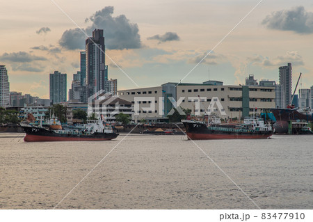 Two cargo ship parked in the middle of the Chao Phraya River. 83477910