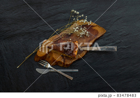 Slice of delicious fresh Tartellette creme brulee a la vanille on a wooden plate. Slice of delicious fresh Tartellette creme brulee a la vanille on a wooden plate. 83478483