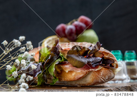 A delicious Smoked salmon sesame bread sandwich on a wooden plate. 83478848