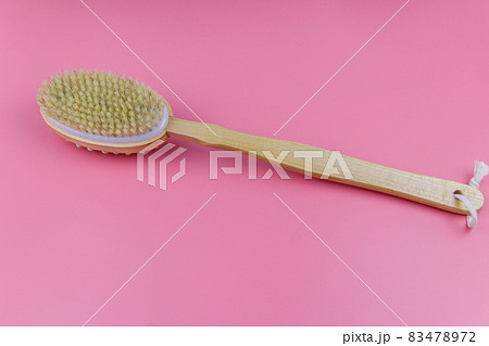 Massage brush on a pink background Massage brush on a pink background 83478972