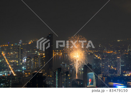 Stunning aerial view of Fireworks light up sky from Boats cruise up the Chao Phraya River. 83479150