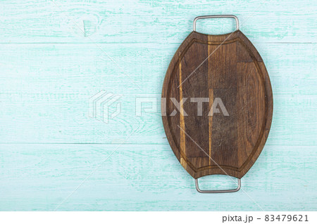 Empty cutting board on a wooden background. Top view. 83479621