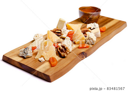 Close-up view of delicious cheese plate with nuts on wooden tabletop 83481567