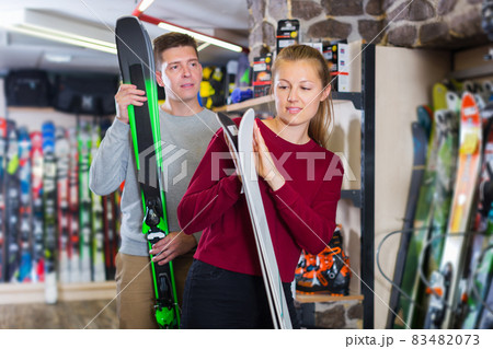Woman with man are choosing ski Woman with man are choosing ski 83482073