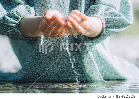 Hands Of A Woman In A Dress That Scoops Water Stock Photo 4528