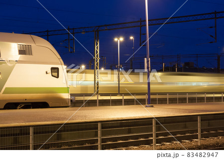 Train in motion on the station at night, long exposure photo. 83482947