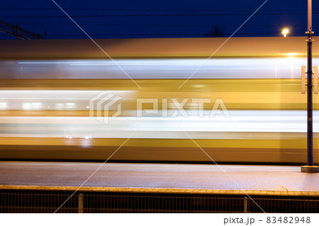 Train in motion on the station at night, long exposure photo. Train in motion on the station at night, long exposure photo. 83482948