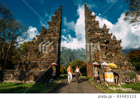 Traveling couple in Bali. Happy couple vacationing in Asian countries. Couple at the Bali gate. A man and a woman traveling on the island of Bali Indonesia. The couple is traveling in Indonesia Traveling couple in Bali. Happy couple vacationing in Asian countries. Couple at the Bali gate. A man and a woman traveling on the island of Bali Indonesia. The couple is traveling in Indonesia 83483113