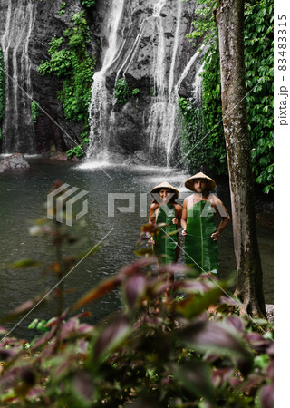 Couple among the greenery. A couple in love in the tropics. The couple is traveling in Asia. Beautiful couple traveling on the island of Bali. A man and a woman against the background of nature 83483315