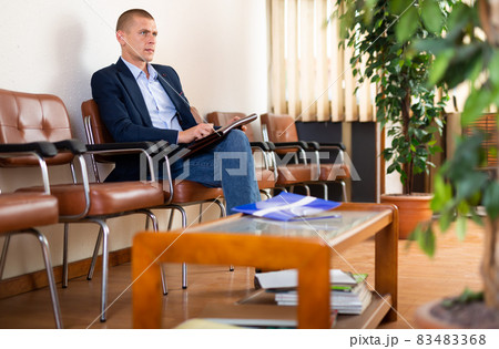 Man with briefcase waiting for job interview at office Man with briefcase waiting for job interview at office 83483368