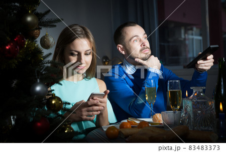 Unhappy couple celebrating New Year Unhappy couple celebrating New Year 83483373