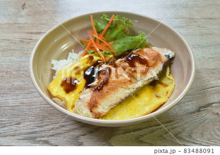 grilled salmon with egg dressing teriyaki sauce topping on Japanese rice in bowl grilled salmon with egg dressing teriyaki sauce topping on Japanese rice in bowl 83488091