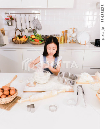Happy little child prepare a bake at kitchen 83488828