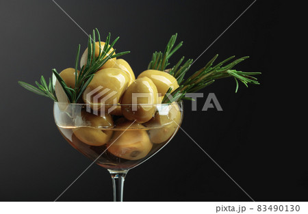 Green olives with rosemary. 83490130