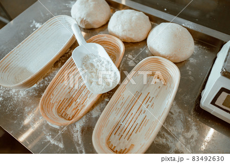Dishes for bread, dough and scoop with flour on metal table Dishes for bread, dough and scoop with flour on metal table 83492630