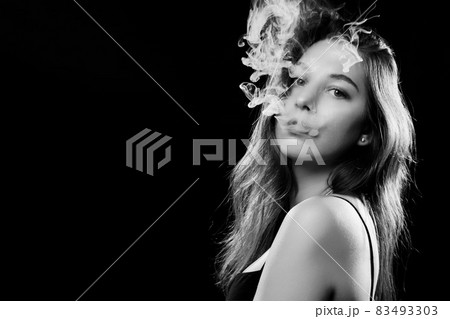 woman blowing smoke woman blowing smoke 83493303