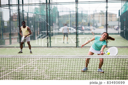 Two sports couples playing padel on tennis court Two sports couples playing padel on tennis court 83493699