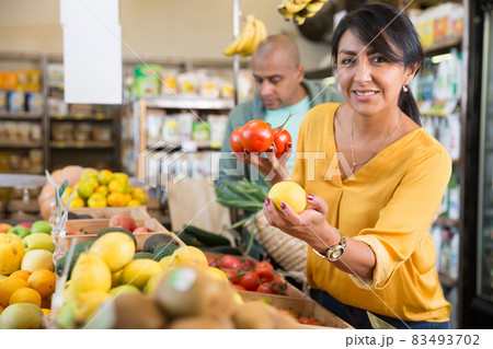 Colombian woman buying fresh vegetables and fruits in supermarket Colombian woman buying fresh vegetables and fruits in supermarket 83493702