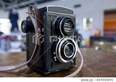 Vintage twin lens camera on the table. Vintage twin lens camera on the table. 83493845