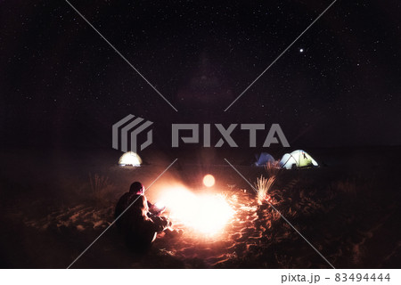 People and fire at night on the beach, Ukraine 83494444