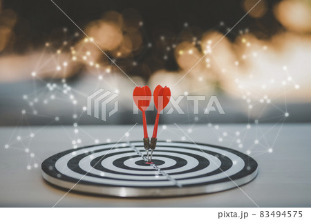 Close up shot of the dart arrow hit on bullseye, red dart arrow hitting in the target center of dartboard Target hit in the center, challenge in business marketing,Target and goal as concept. 83494575