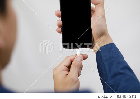 Close-up view of smartphone charging Low battery, White USB Cable Connected With Mobile Phone on the white background 83494581