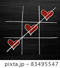 Tic tac toe game with chalk hearts, XO noughts and crosses Valentine's Day style 83495547