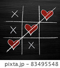 Tic tac toe game with chalk hearts, XO noughts and crosses Valentine's Day style 83495548
