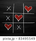 Tic tac toe game with chalk hearts, XO noughts and crosses Valentine's Day style 83495549