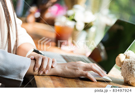 Closeup woman holding her wrist pain from using computer. Office 83497924