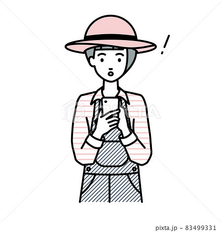 立ってスマートフォンを操作して何かに気づいて驚いた農家の女性 83499331