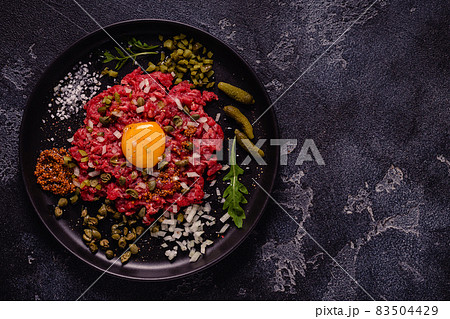 fresh beef tartar with tasty vegetables 83504429