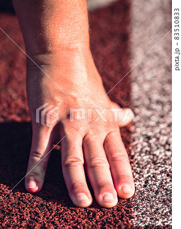 Starting line with outstretched fingers. Stadium racetrack 83510833