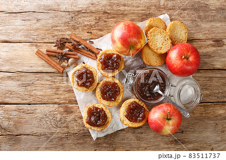 apple butter prepared from organic apples and toasts closeup. Horizontal top view apple butter prepared from organic apples and toasts closeup. Horizontal top view 83511737