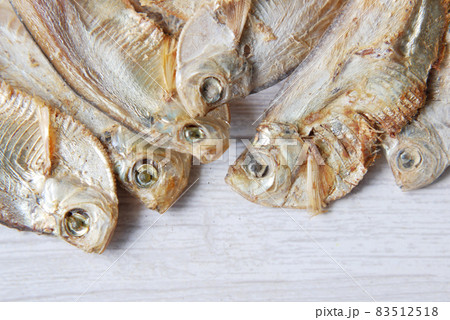 close up of dried fish on blue backgrund close up of dried fish on blue backgrund 83512518